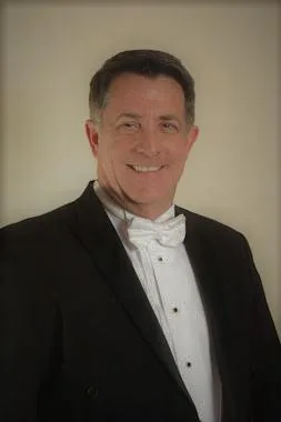 tim-headshot Tim wearing a tuxedo and white tie